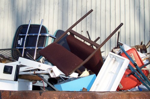 Professional waste removal team handling furniture